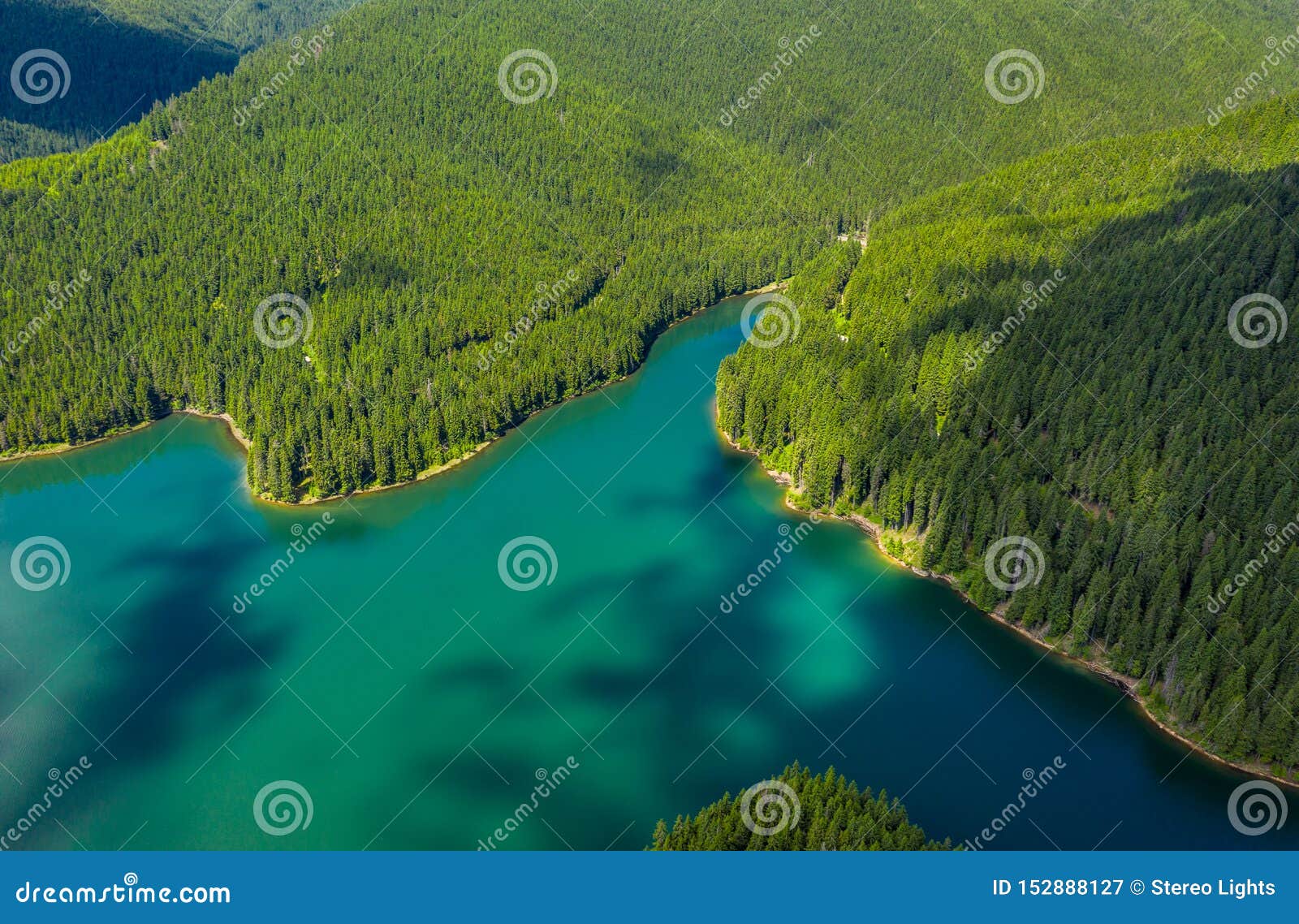 Mountain Lake With Turquoise Water And Green Trees Reflection In The