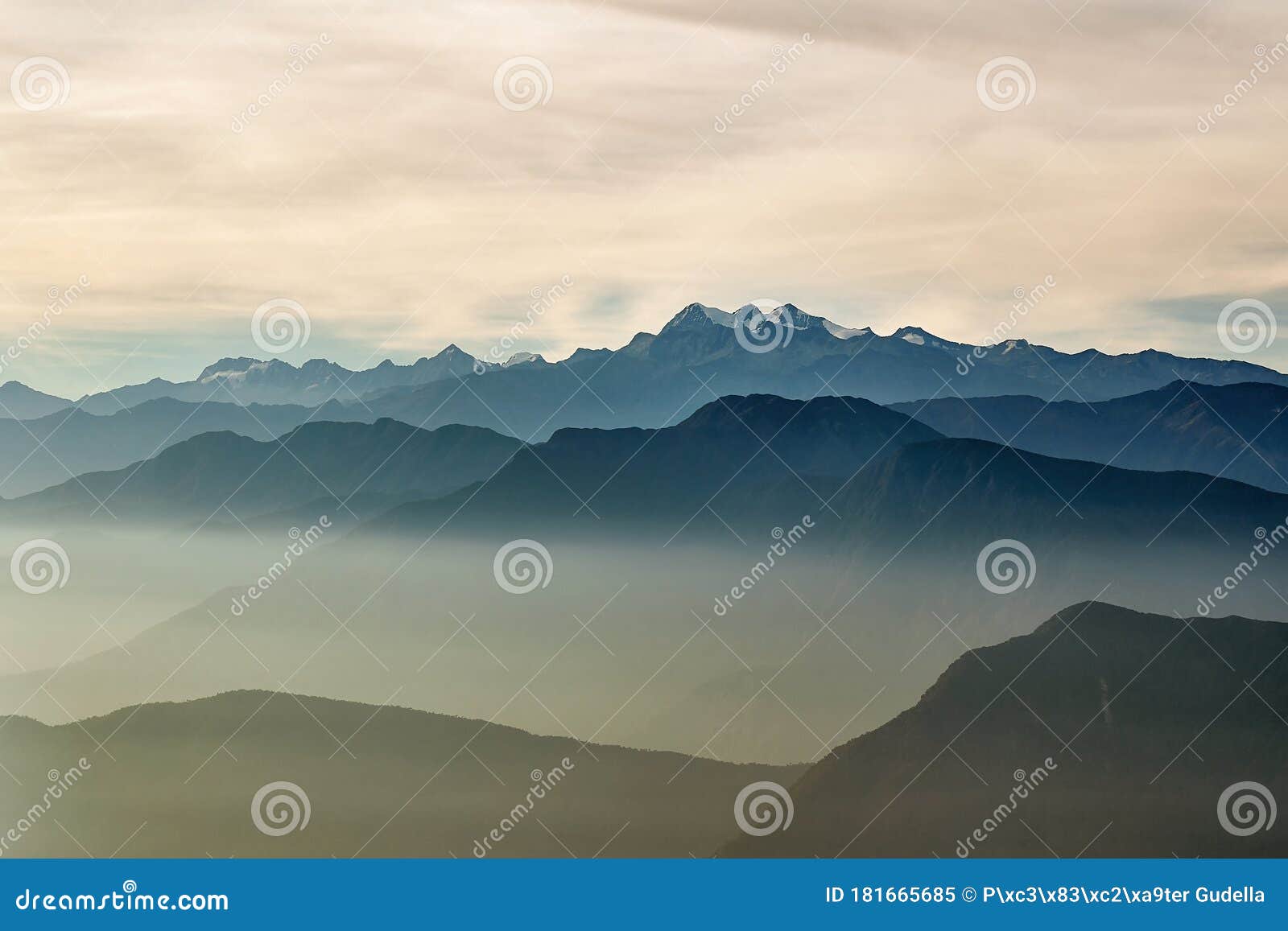 mountain peaks above moving clouds and mist