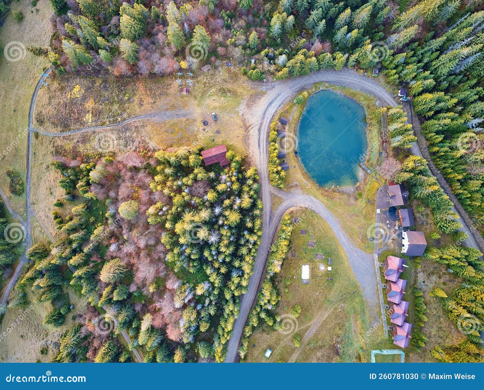 mountain resort, village and hotel with pond and forest. aerial top view on lake, rural dirt road in woods, ski lift. travel