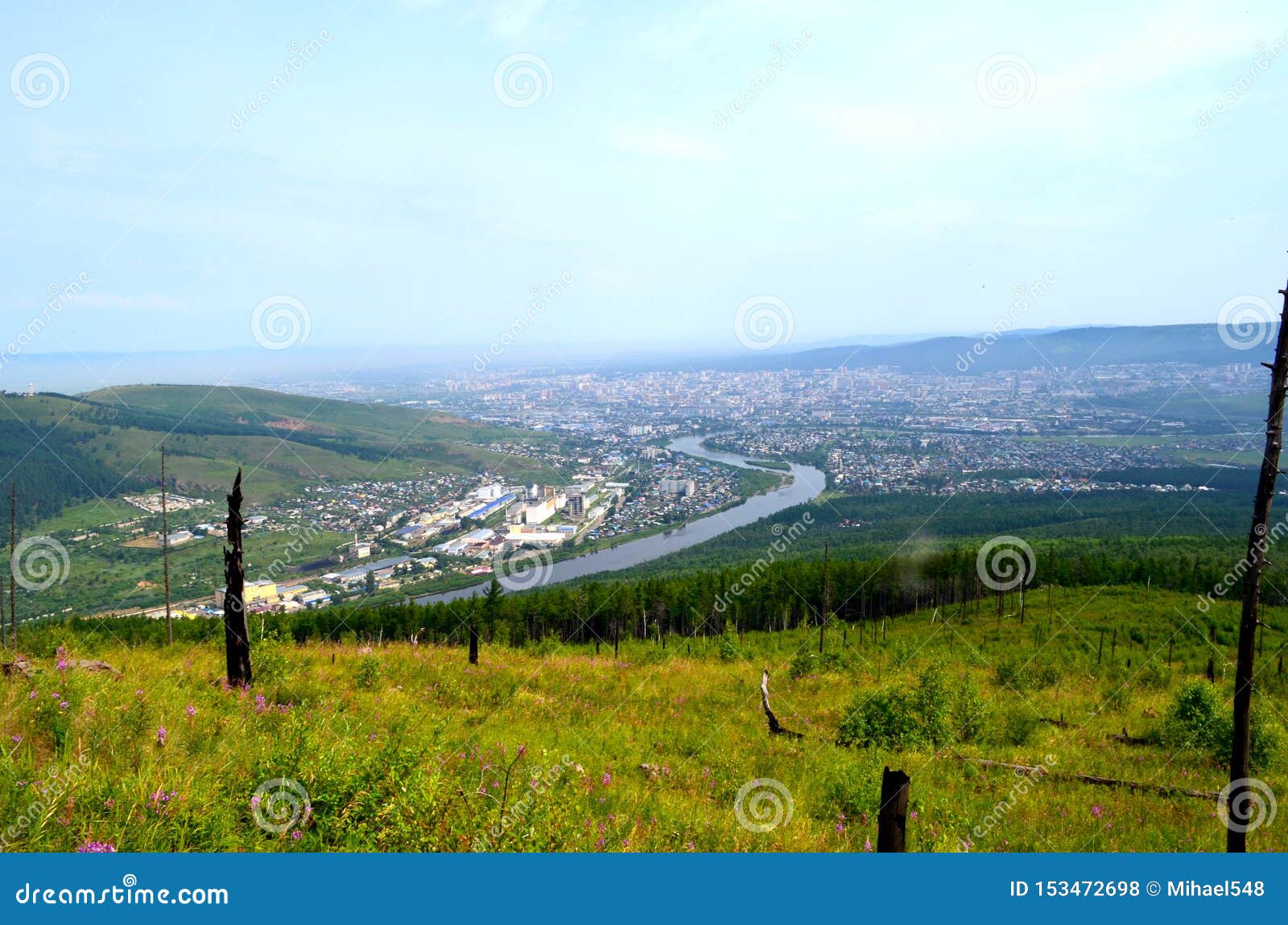 mountain taiga landscape with views of the river valley, taiga, fells, city.