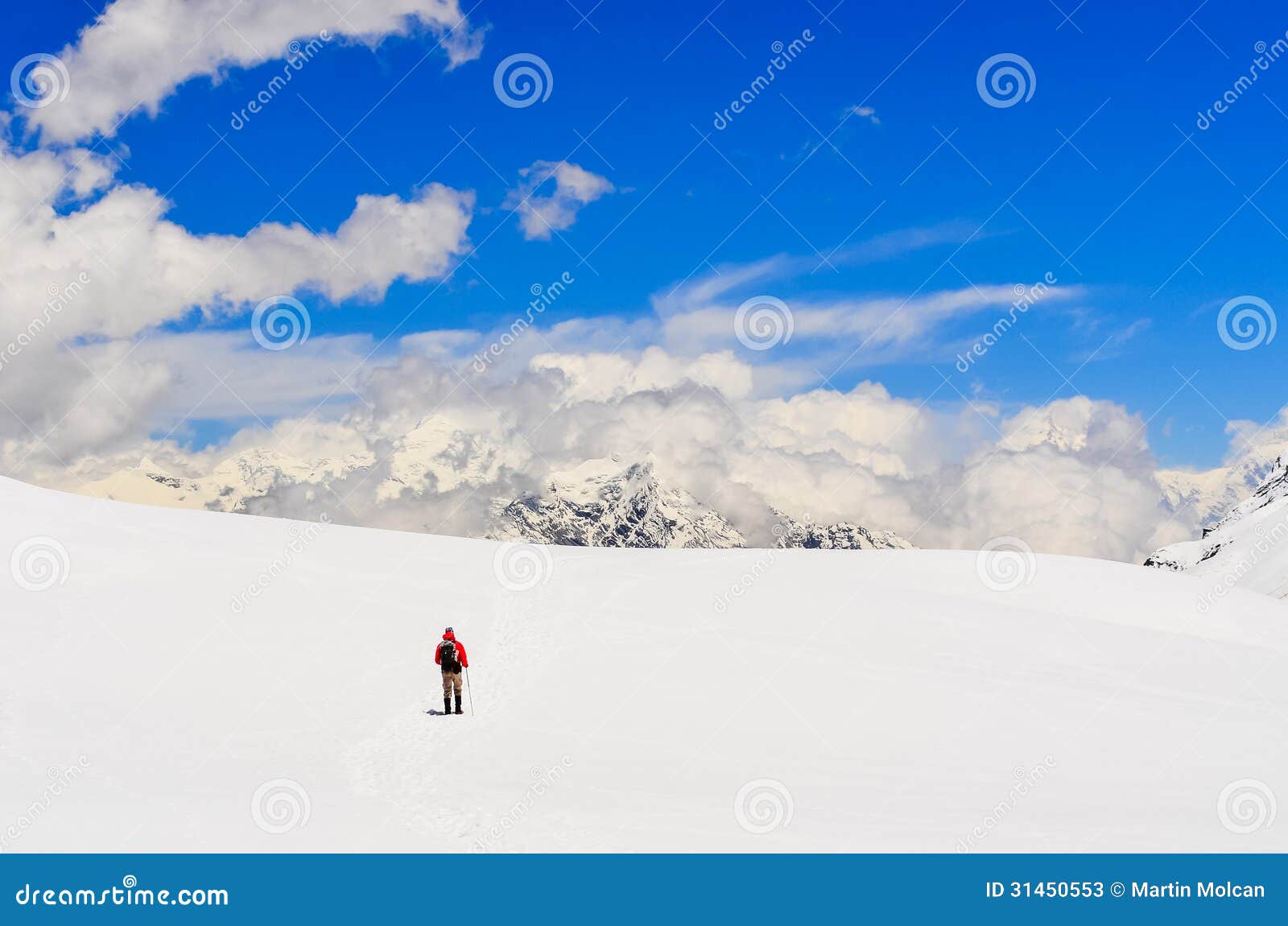 mountain trekker walking in high winter himalayas mountains