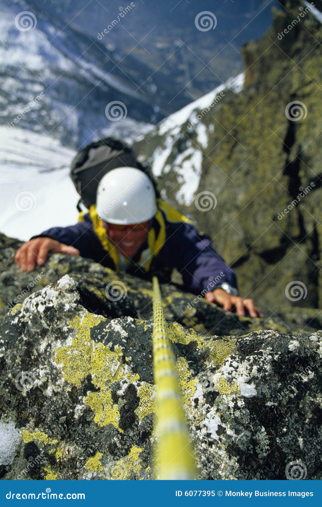 mountaineer scaling snowy rock face