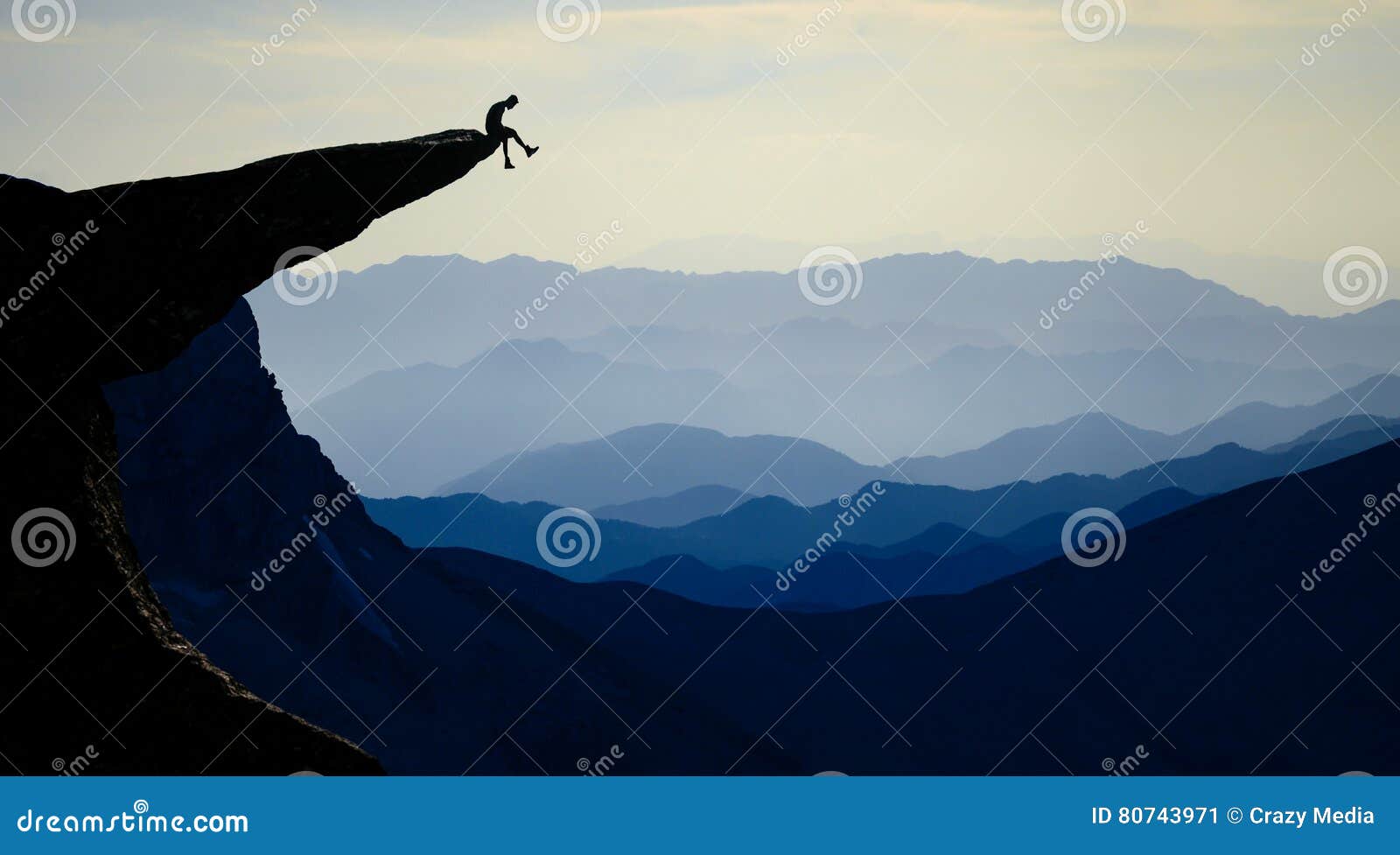 mountaineer sitting on rocky outcropping