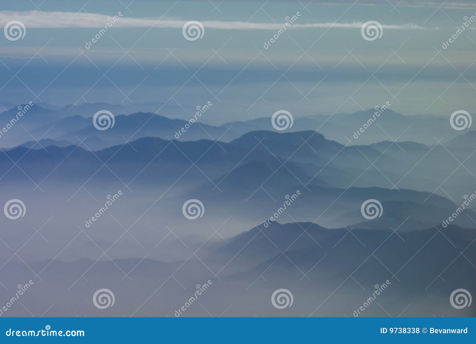 mountainous peaks exposed through cloud