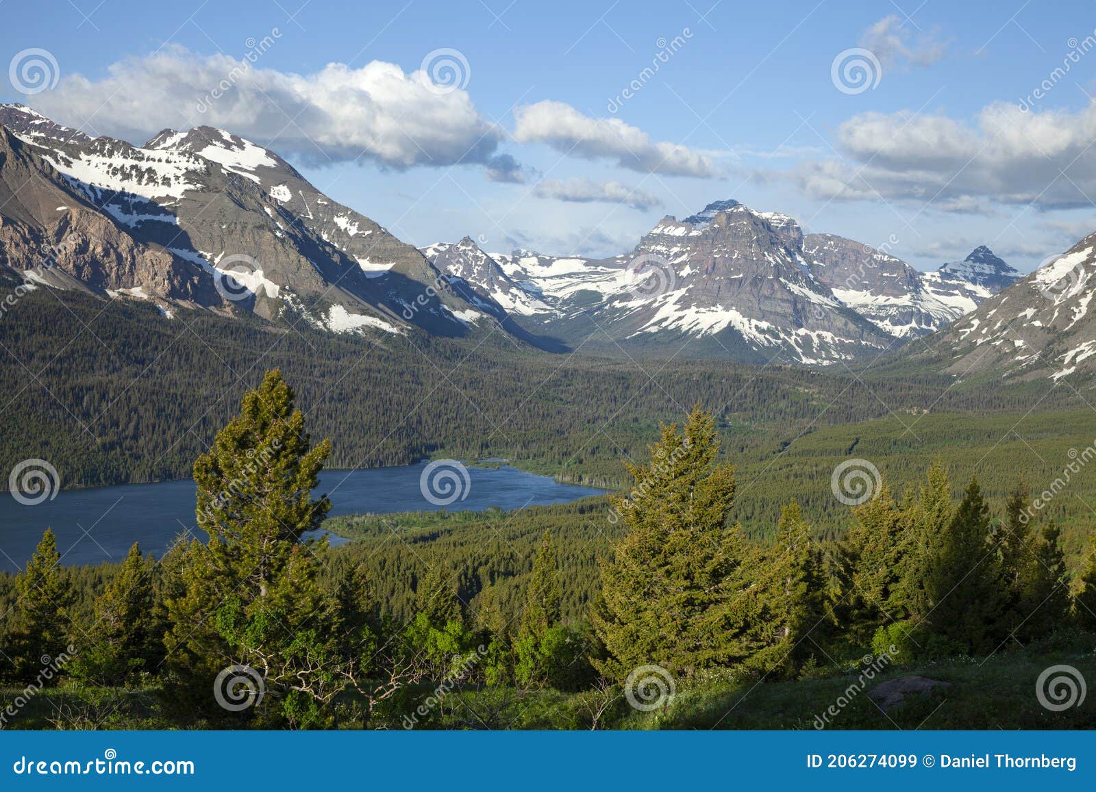 mountains above lower two medicine lake near glacier national park in montana