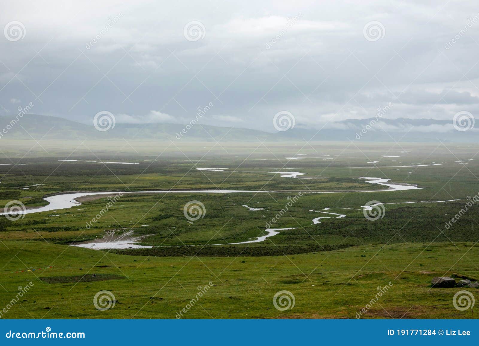the mountains are surrounded by clouds and the wetlands after the rain
