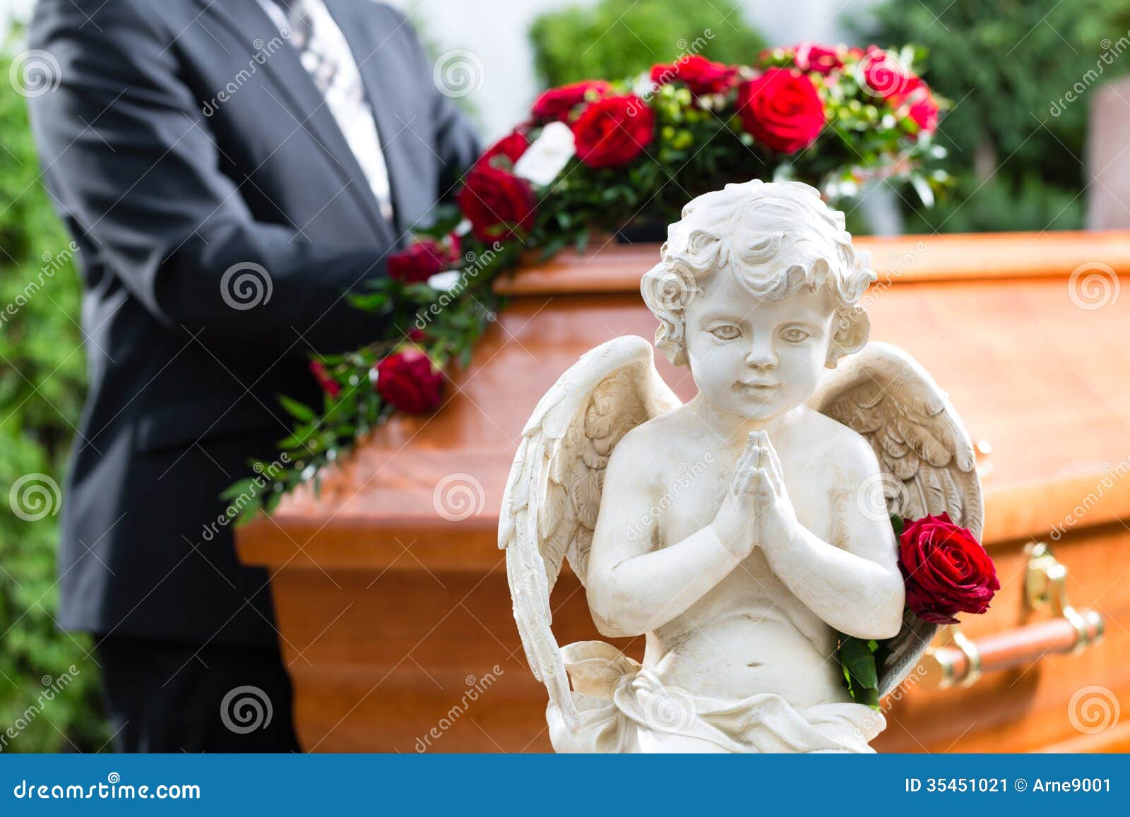 mourning man at funeral with coffin