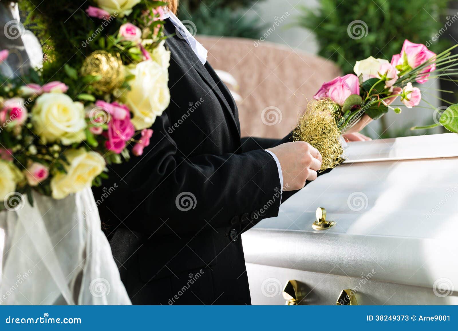 mourning people at funeral with coffin