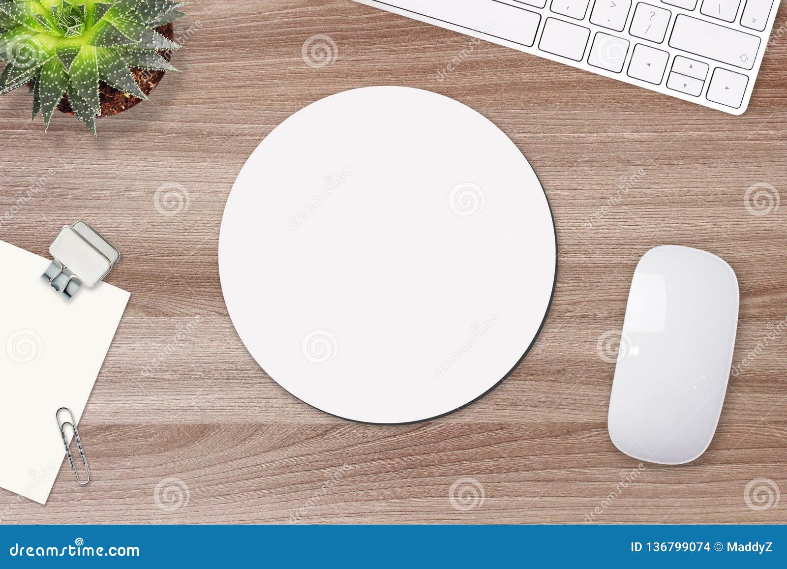 mouse pad mockup. round white mat on the table with props, mouse and keyboard