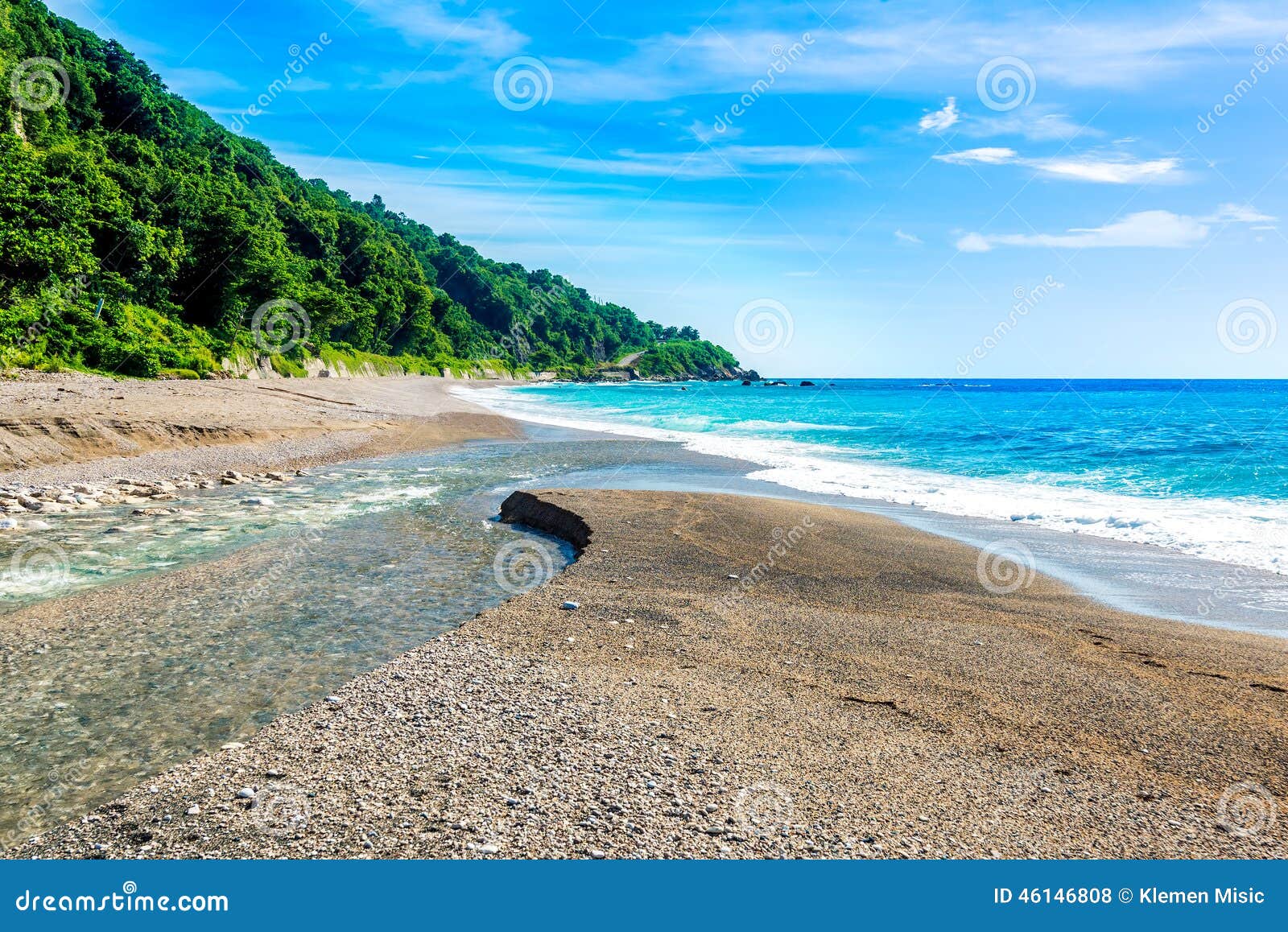mouth of the river to the sea on playa sana rafael beach, barahona, dominican republic