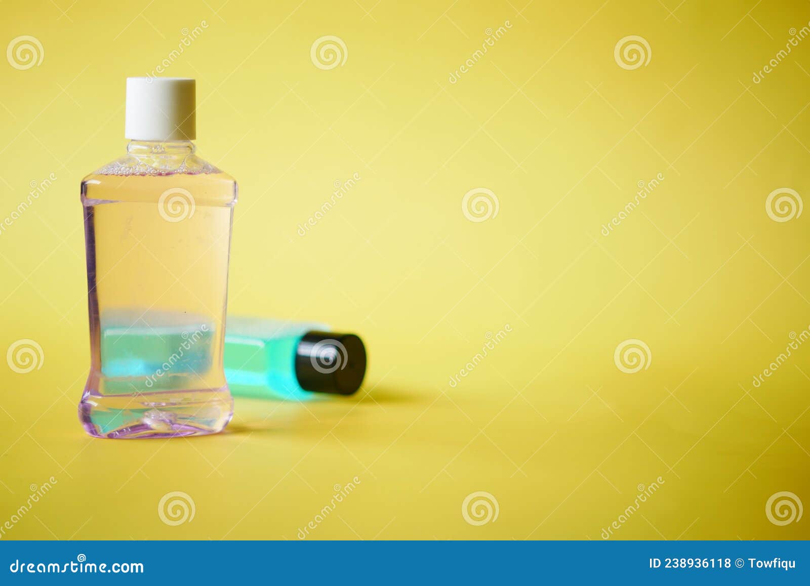 Mouthwash Liquid in a Container on Yellow Background Stock Photo