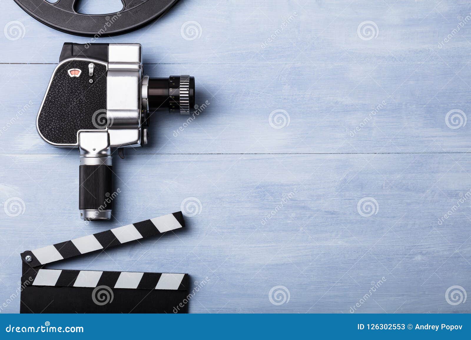 https://thumbs.dreamstime.com/z/movie-camera-film-reel-clapper-board-high-angle-view-movie-camera-film-reel-clapper-board-wooden-plank-126302553.jpg