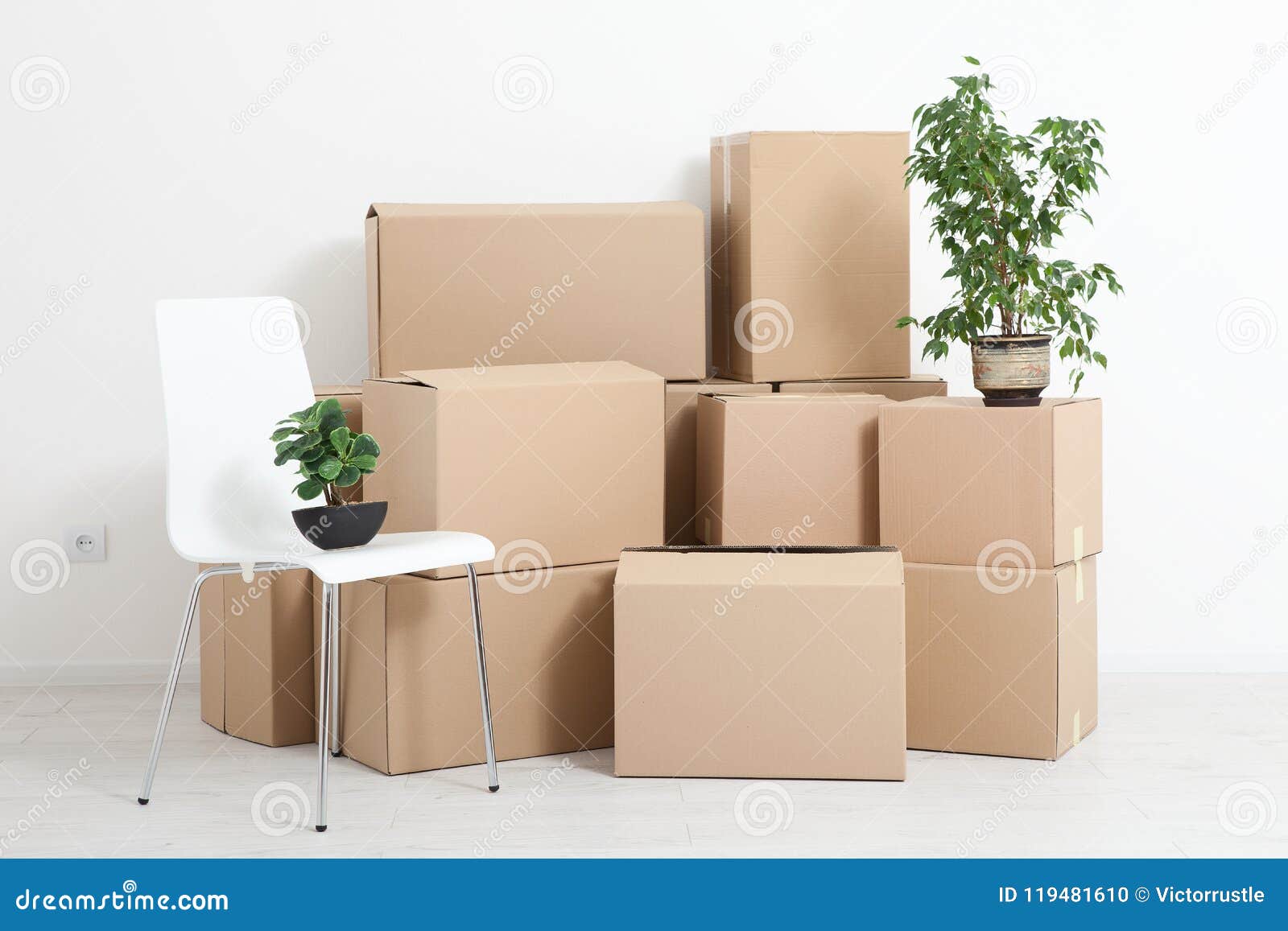 Moving into a New Apartment. Move Lots of Cardboard Boxes in an Empty