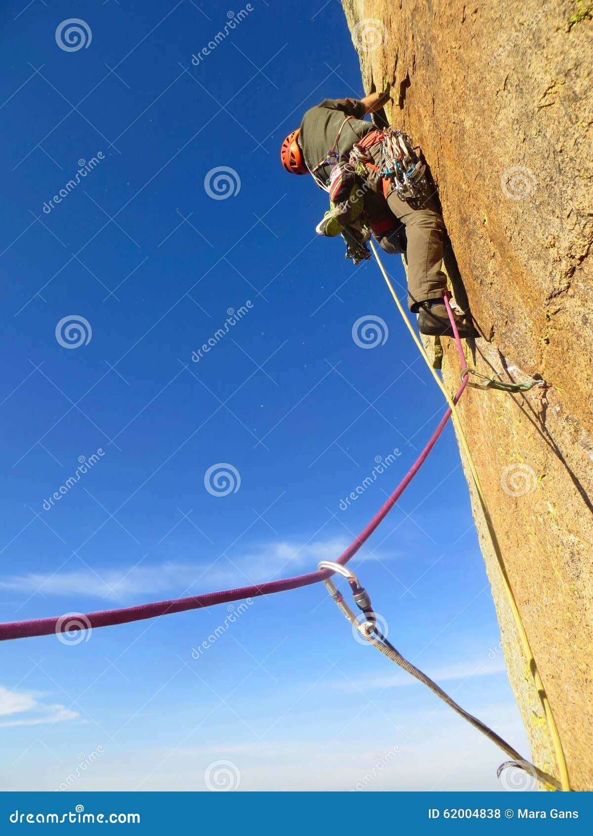 Motivate Traditional Rock Climber Working His Way Up a Cliff Editorial