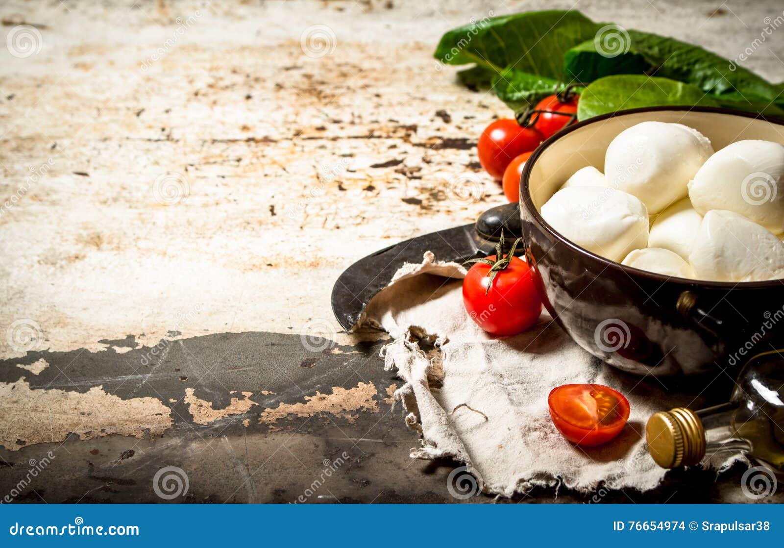 Mozzarella Cheese, Tomatoes, Olive Oil and an Old Knife. Stock Photo