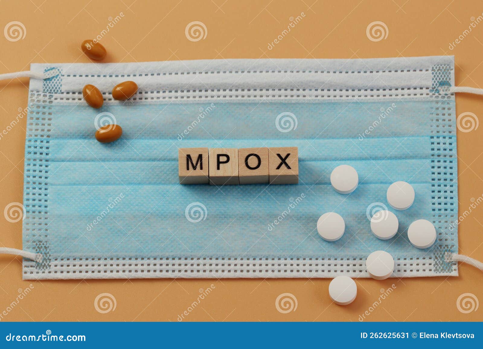 mpox is laid out with wooden cubes on a surgical face mask.