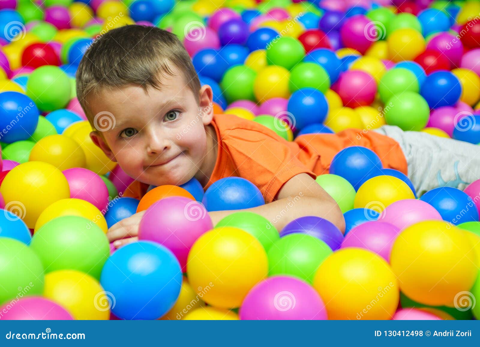 Muchacho De Risa Feliz Que Se Divierte En Hoyo De La Bola En Parque De  Atracciones De Los Niños Y Centro Del Juego Niño Que Juega Foto de archivo  - Imagen de