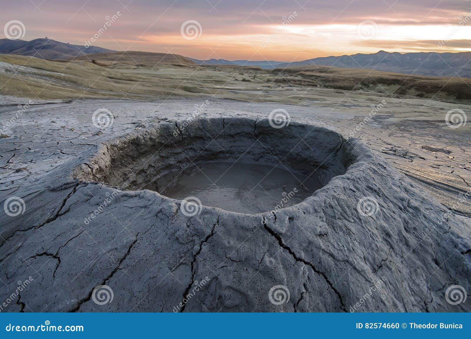 bubbling mud. mud volcano at sunset - landmark attraction in buzau, romania