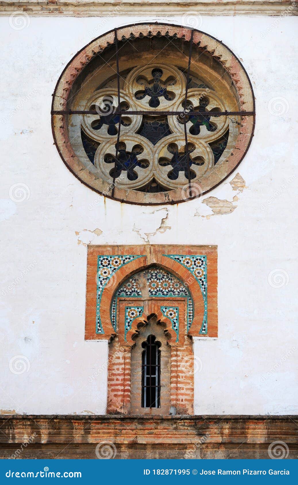 mudejar style window with tiles -alicatados-  and rose window of the church of omnium sanctorum in seville, spain