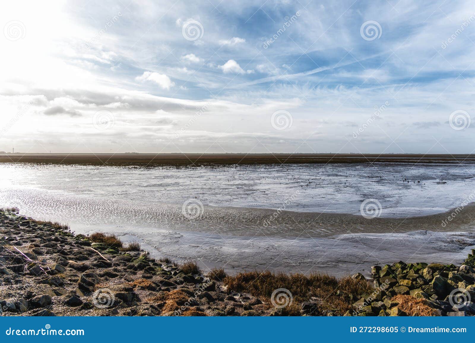 mudflats area at low tide in the 'wadden' sea near the village 'holwerd' in the netherlands