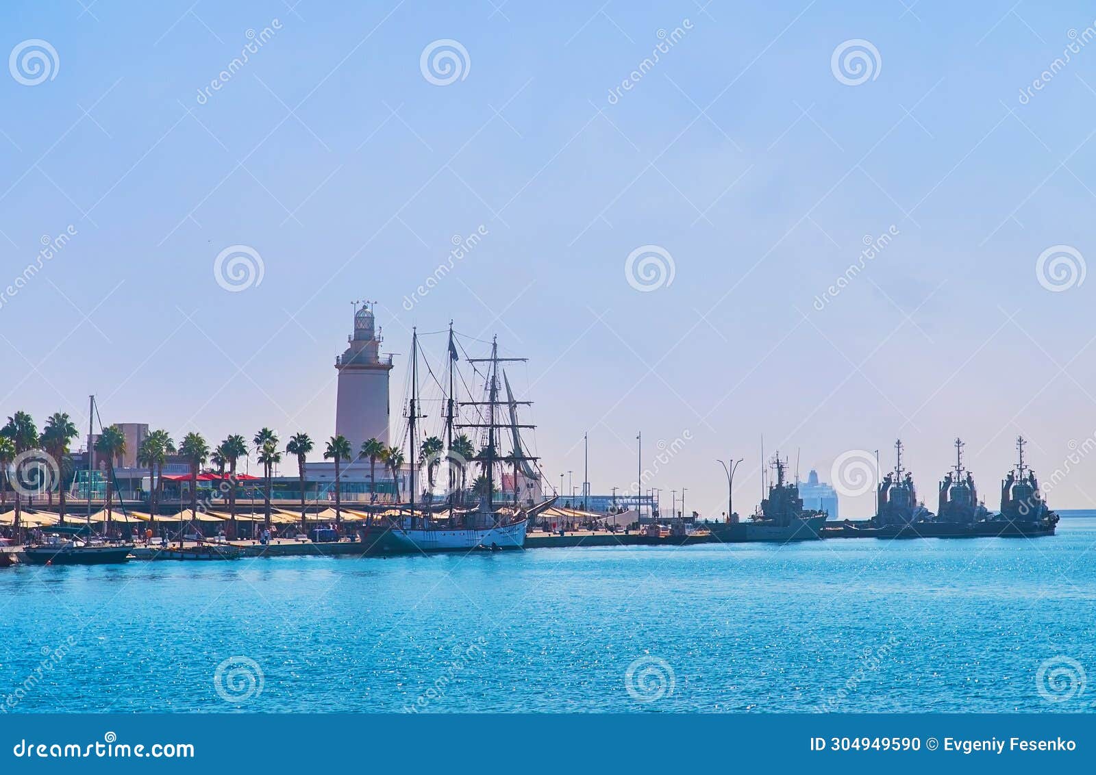 muelle uno and la farola lighthouse, malaga port, spain