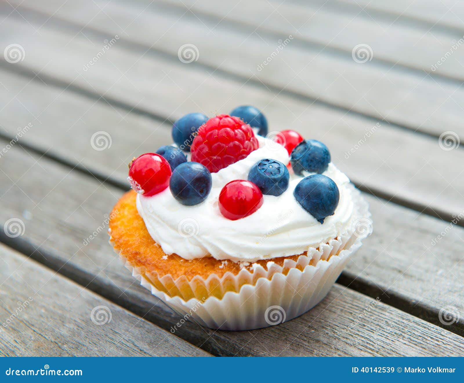 Muffin with fruits on wooden board