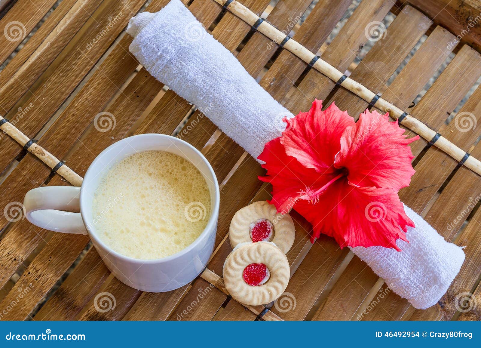 mug with cappuchino on bamboo table, coffee cup in the mor