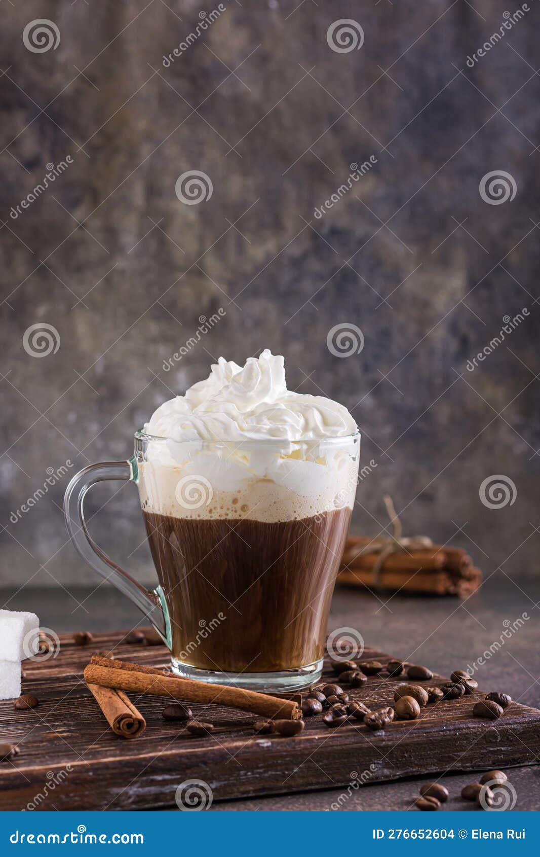 Mug of Viennese Coffee with Whipped Cream and Cinnamon on the Table