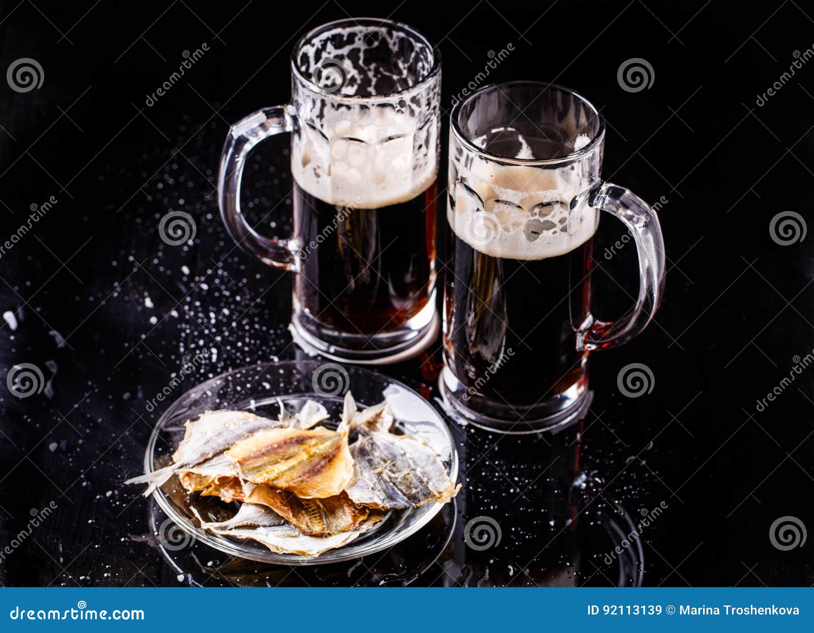 Mugs of beer with fish stock image. Image of brewing 92113139