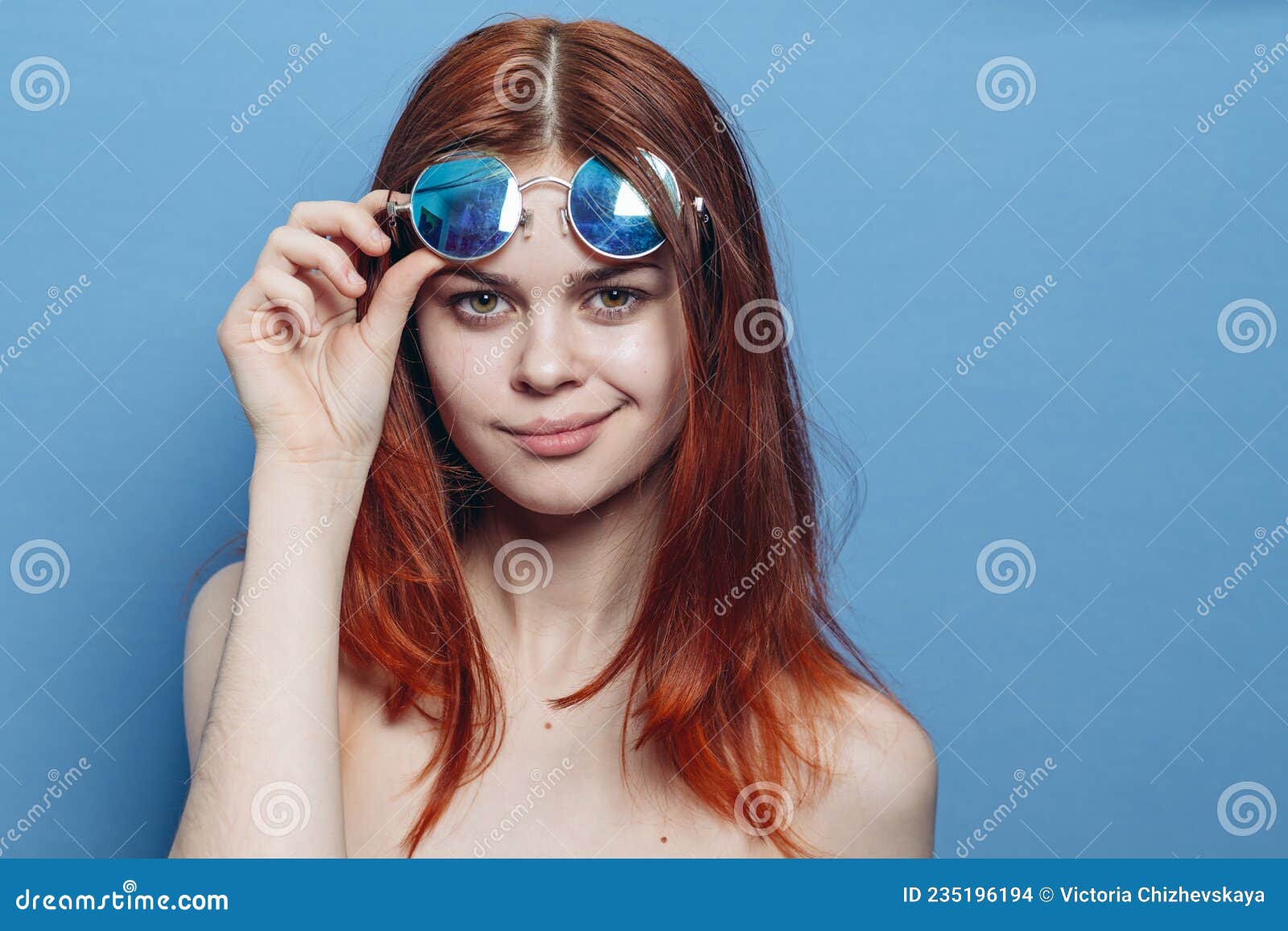 Mujer Pelirroja Perky Con Lentes Azules Hombros Desnudos Posando Foto