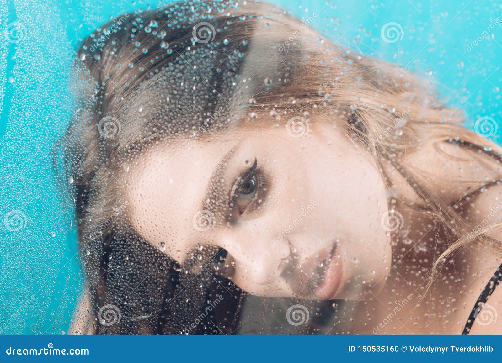 Woman Behind Plastic Sheet With Water Drops Shower And Hygiene Spa Treatment Foto De Stock