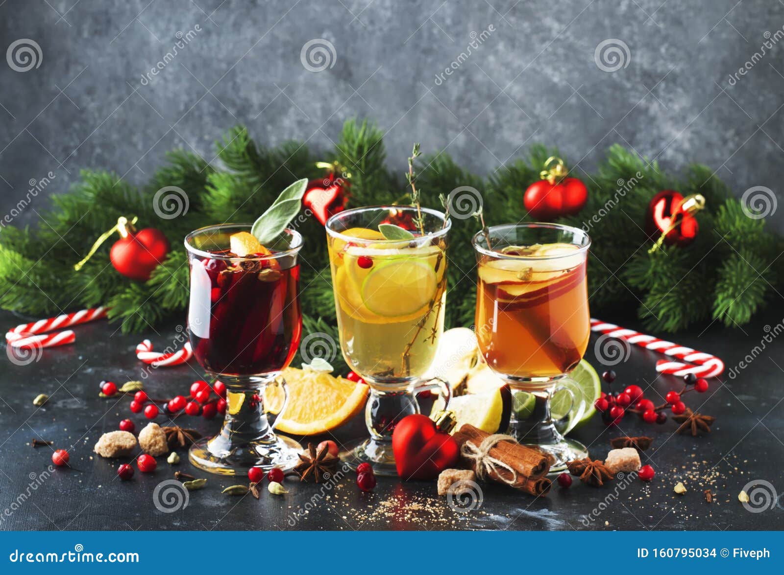 mulled wine and mulled cider. hot winter drinks and cocktails for christmas or new year`s eve in glass mugs with spices and citru
