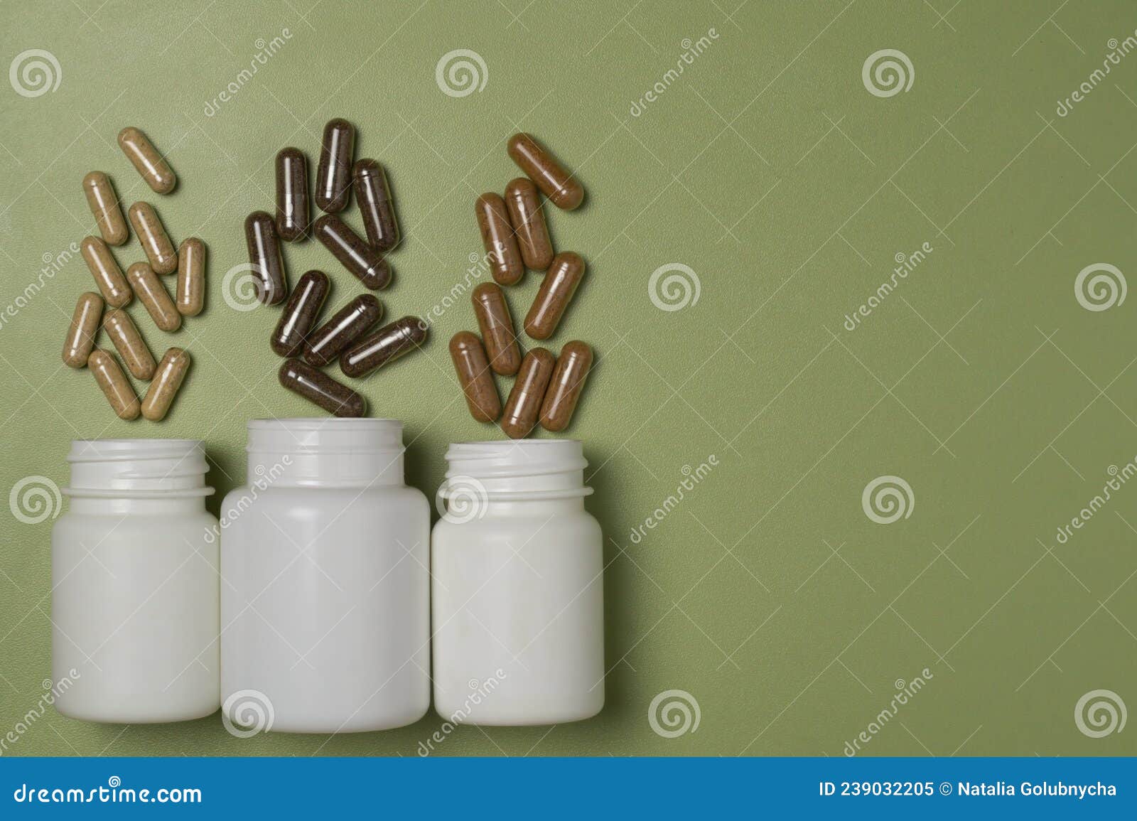 multi-colored capsules with dietary supplements fly out of three white plastic jars