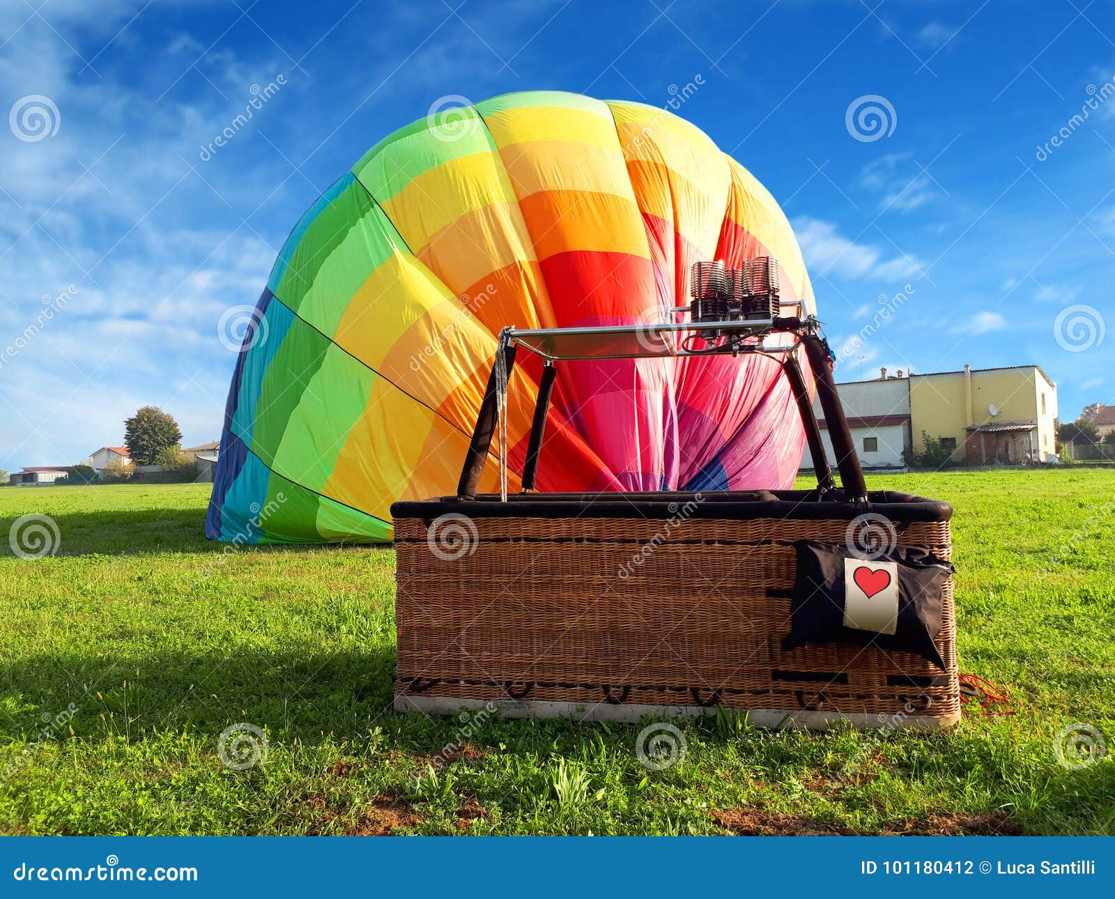 multi colored hot air balloon with red heart in the field