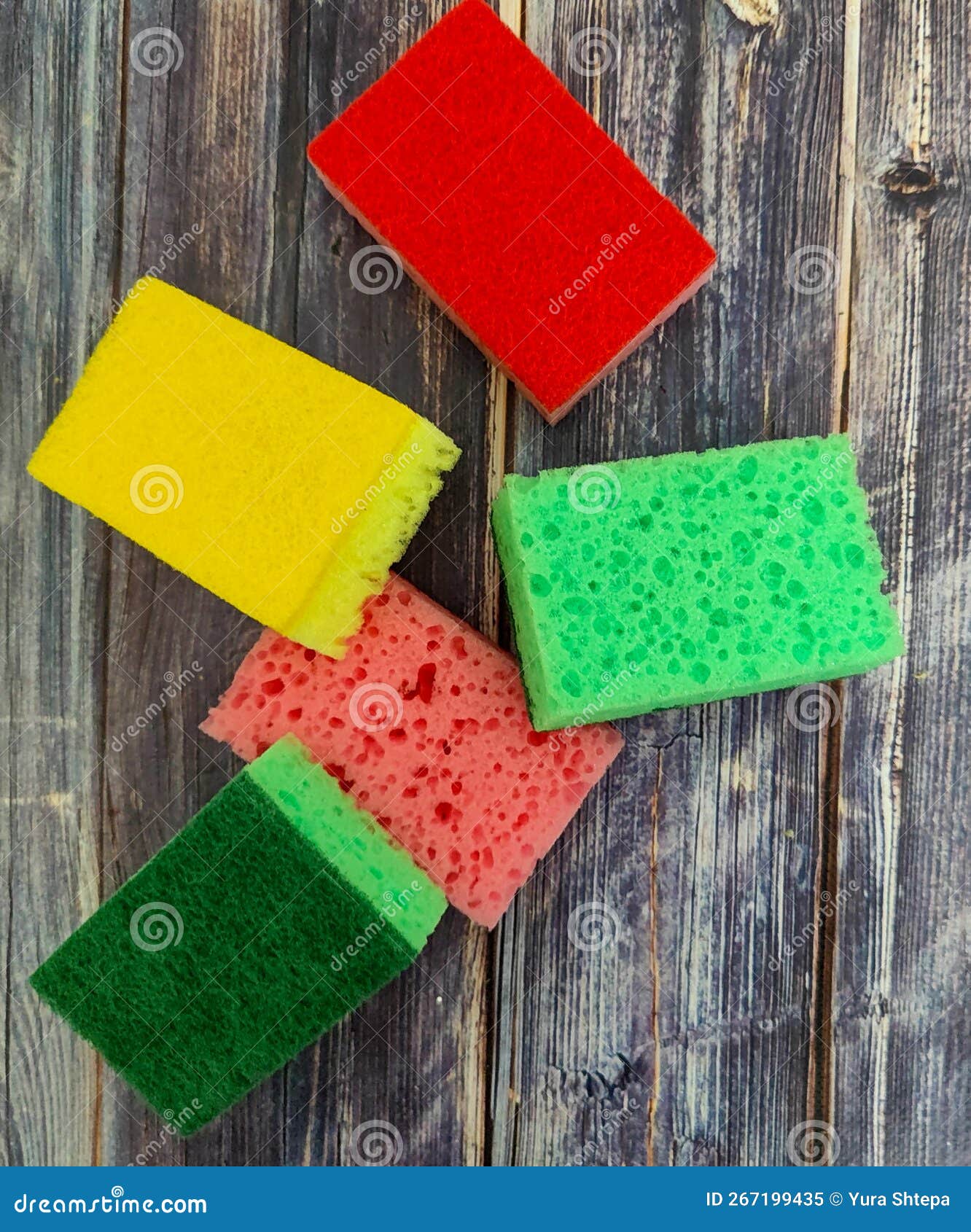 Multicolored Kitchen Sponges for Washing Dishes on a Wooden Table