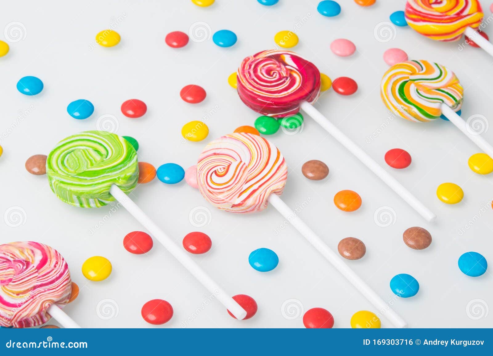 Multi-colored Lollipops, Neatly Arranged and Round Sweet Dragees, on a ...