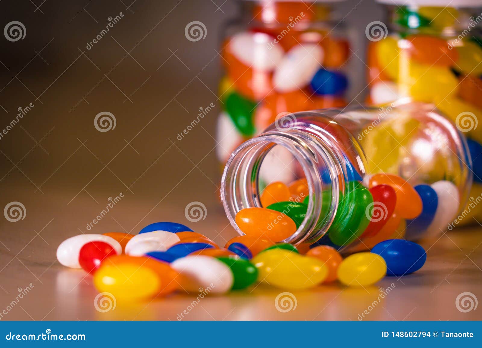 Multi-colored Pills Spilling Out of a Pill Bottle Against a Blurry ...