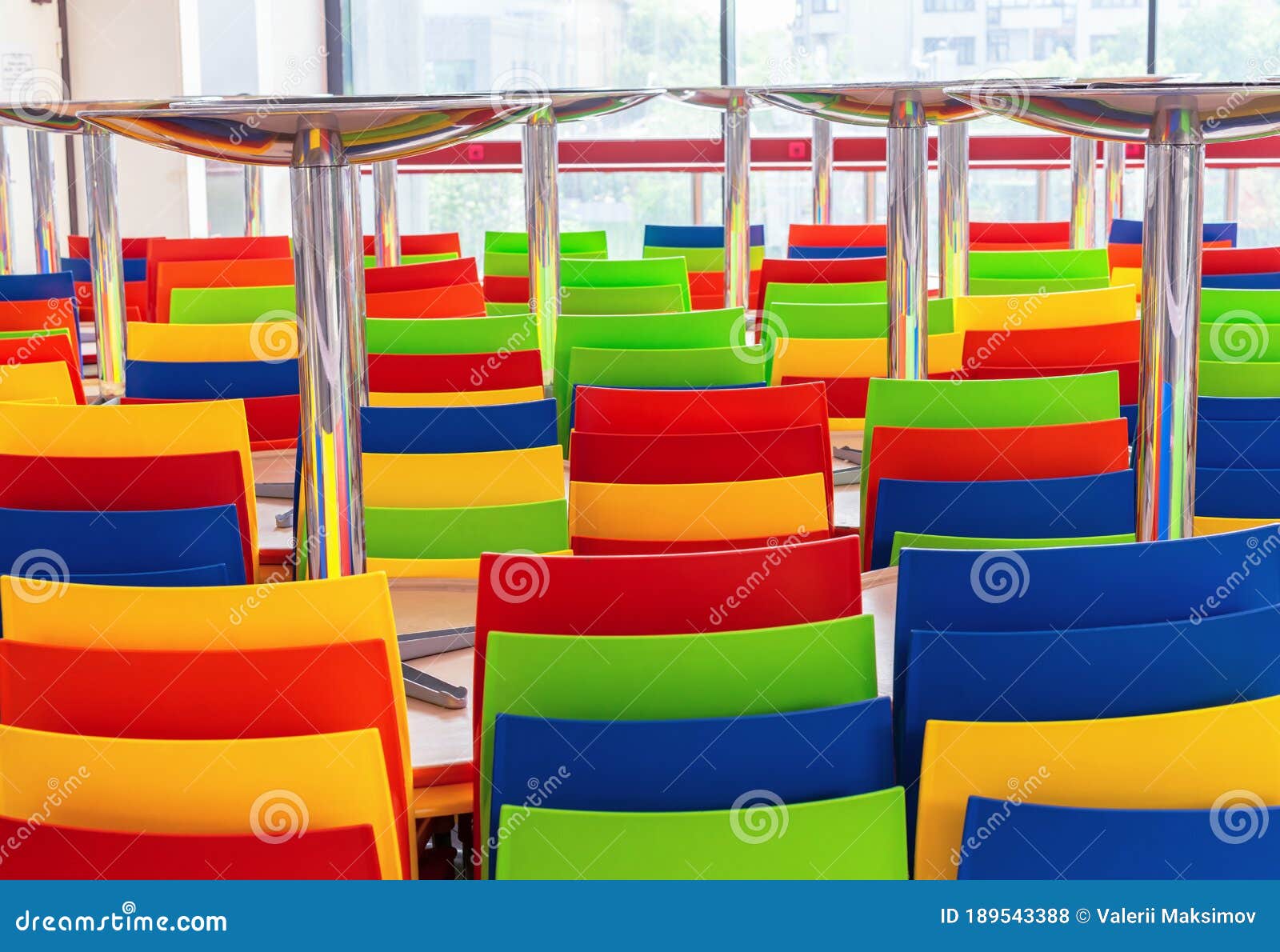 Multicolored Plastic Chairs and Tables in a Closed Cafe Stock Photo
