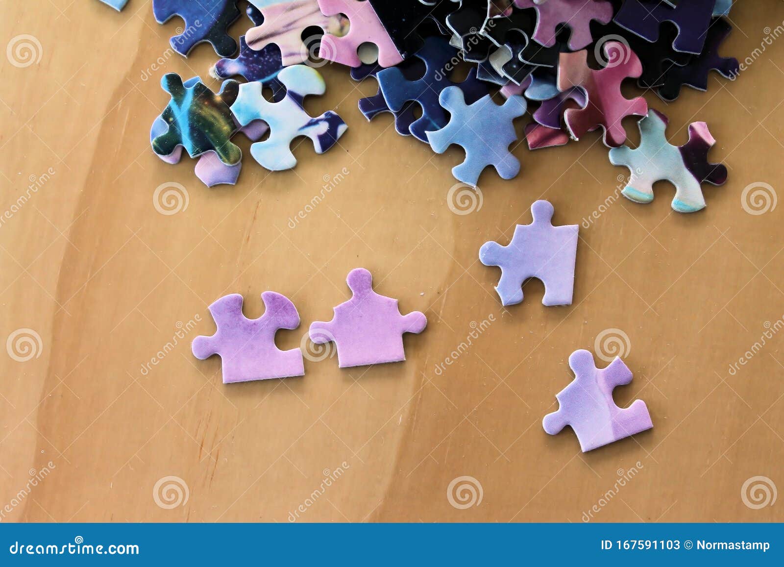 Multi Colored Puzzle Pieces on a Wooden Surface Stock Illustration