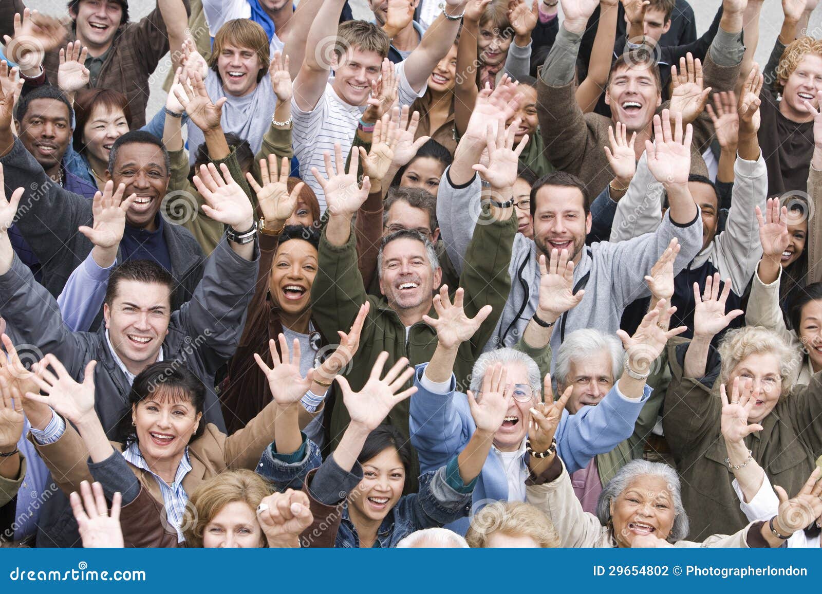 multi ethnic people raising hands together