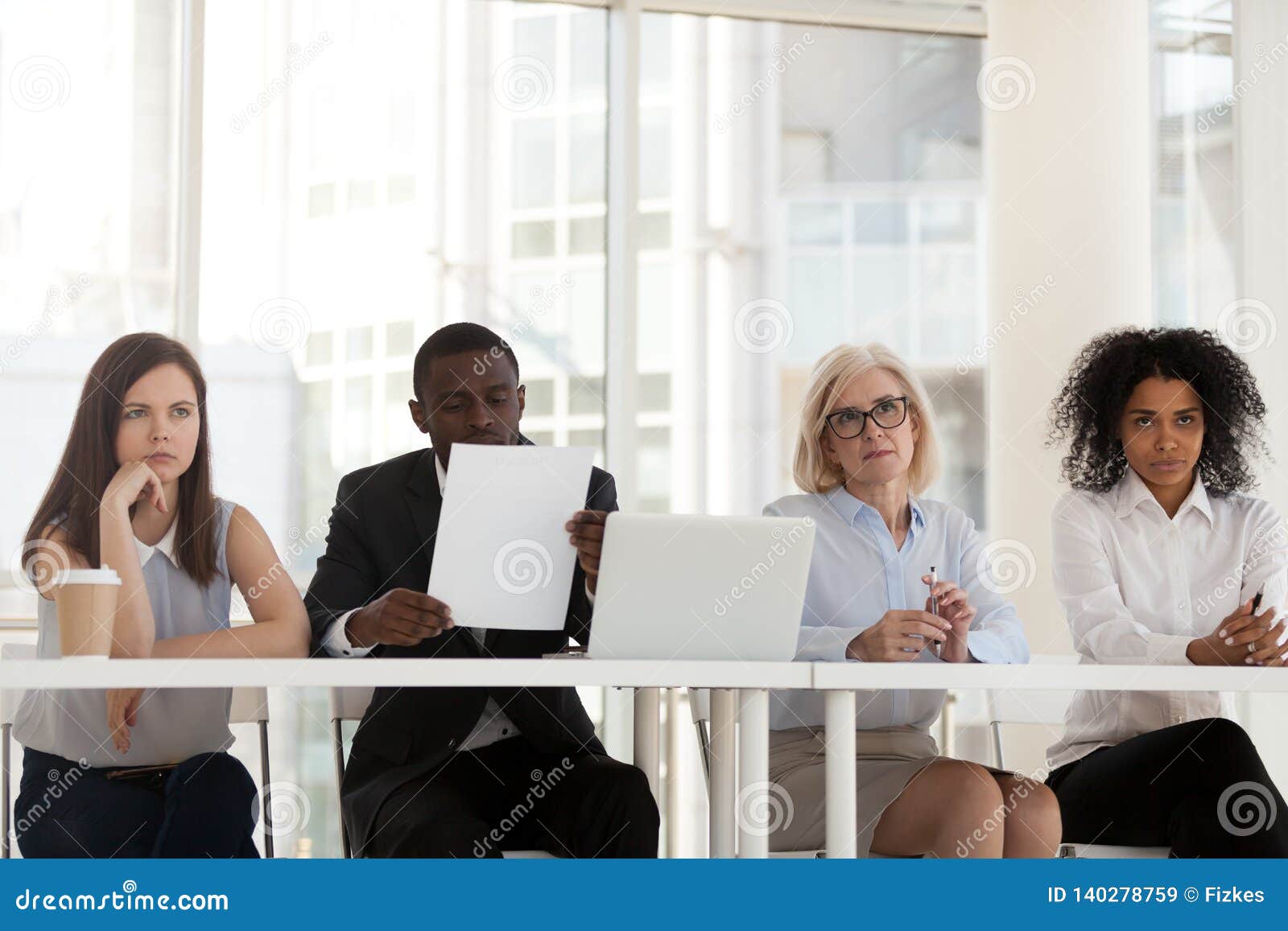 multi-ethnic workers of recruiting agency interviewing applicant