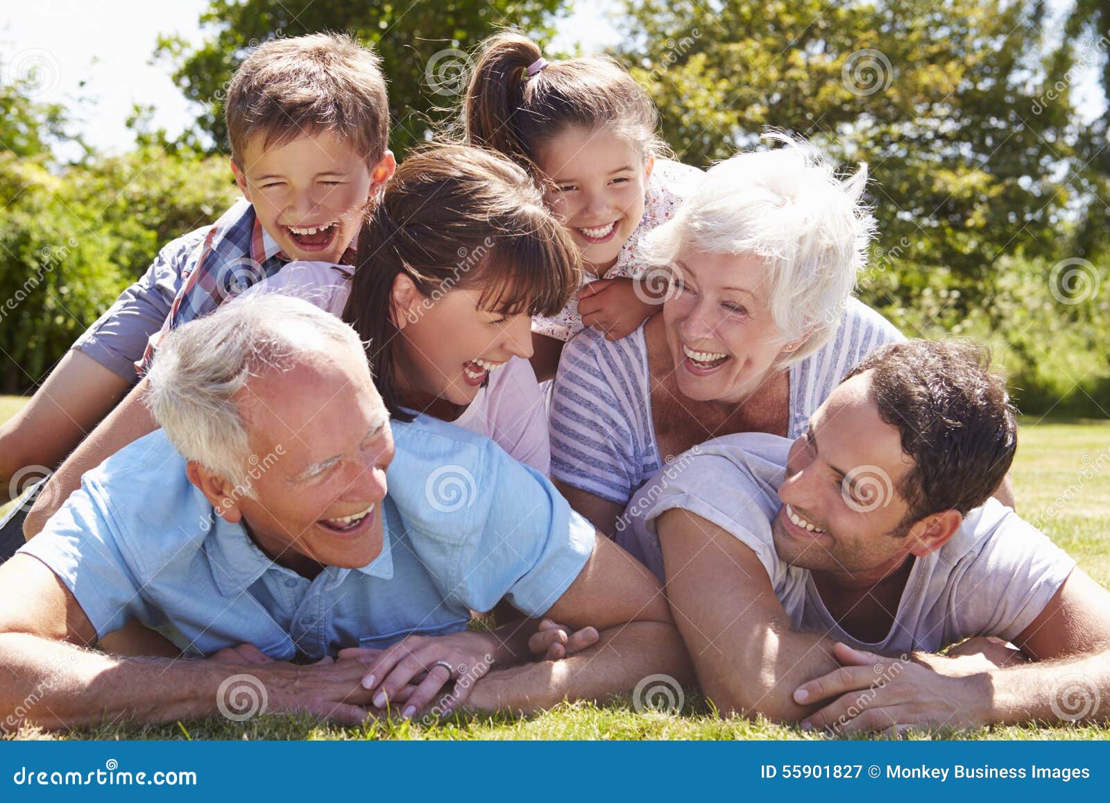 multi generation family piled up in garden together