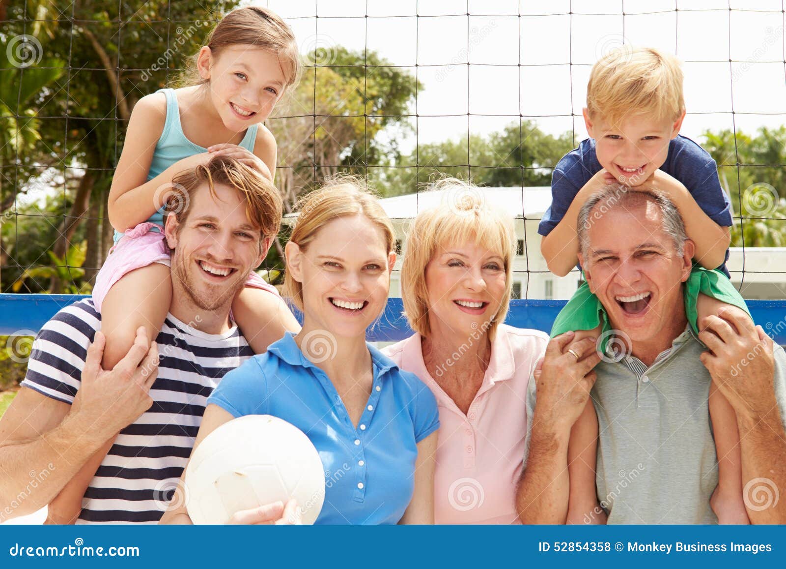 Multi Generation Family Playing Volleyball Together