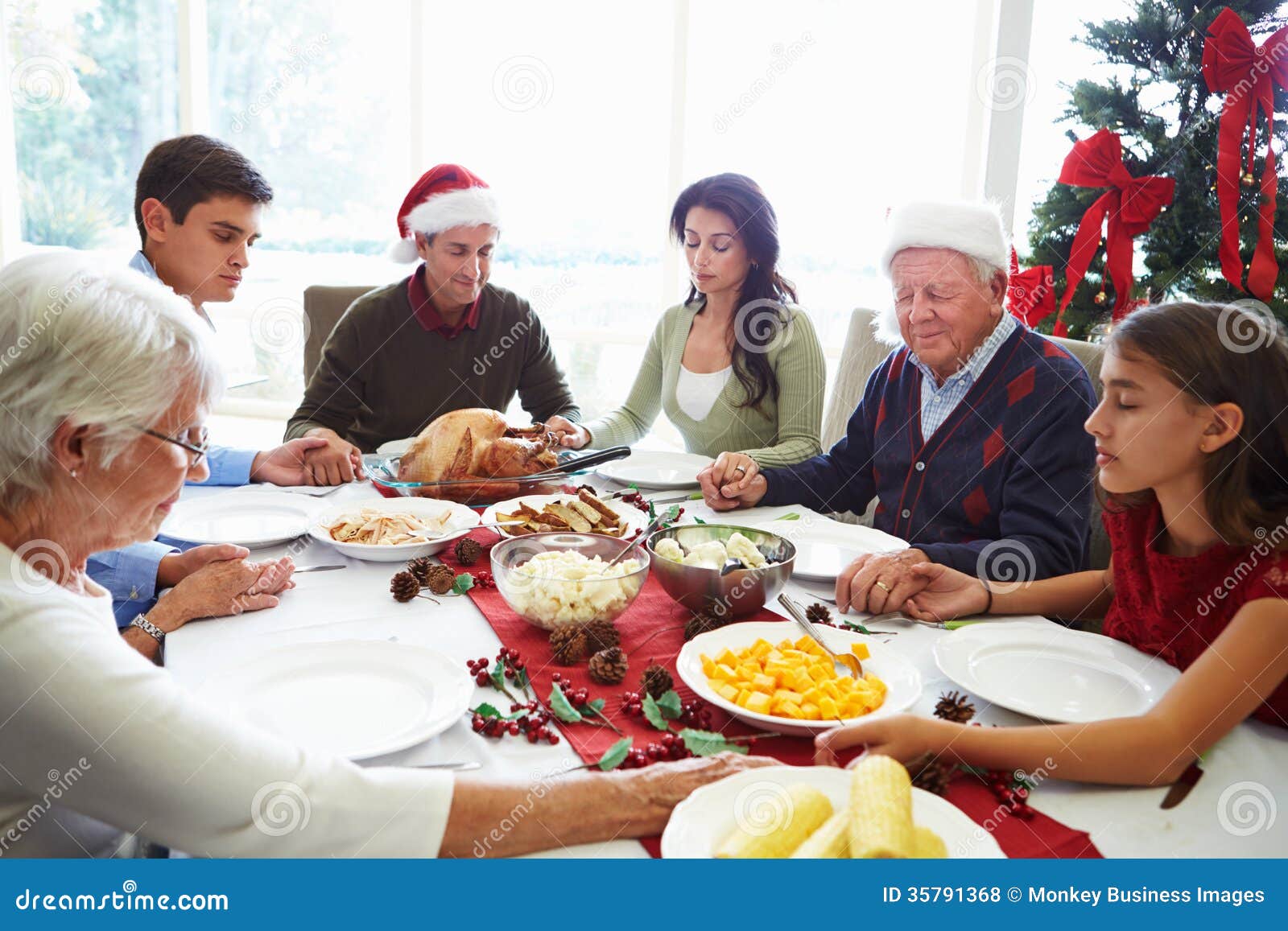 Multi Generation Family Praying before Christmas Meal Stock Photo ...