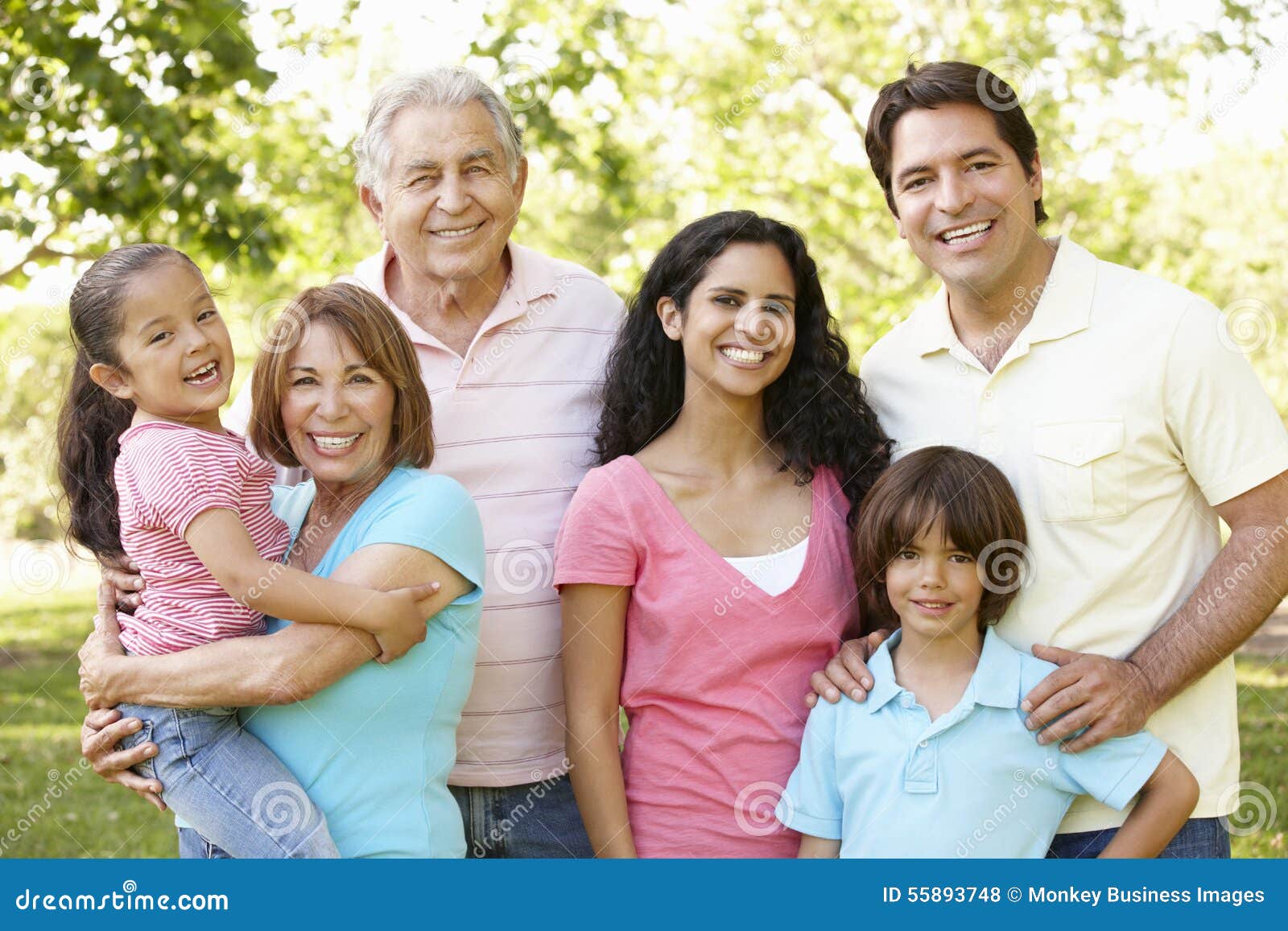 multi generation hispanic family walking in park