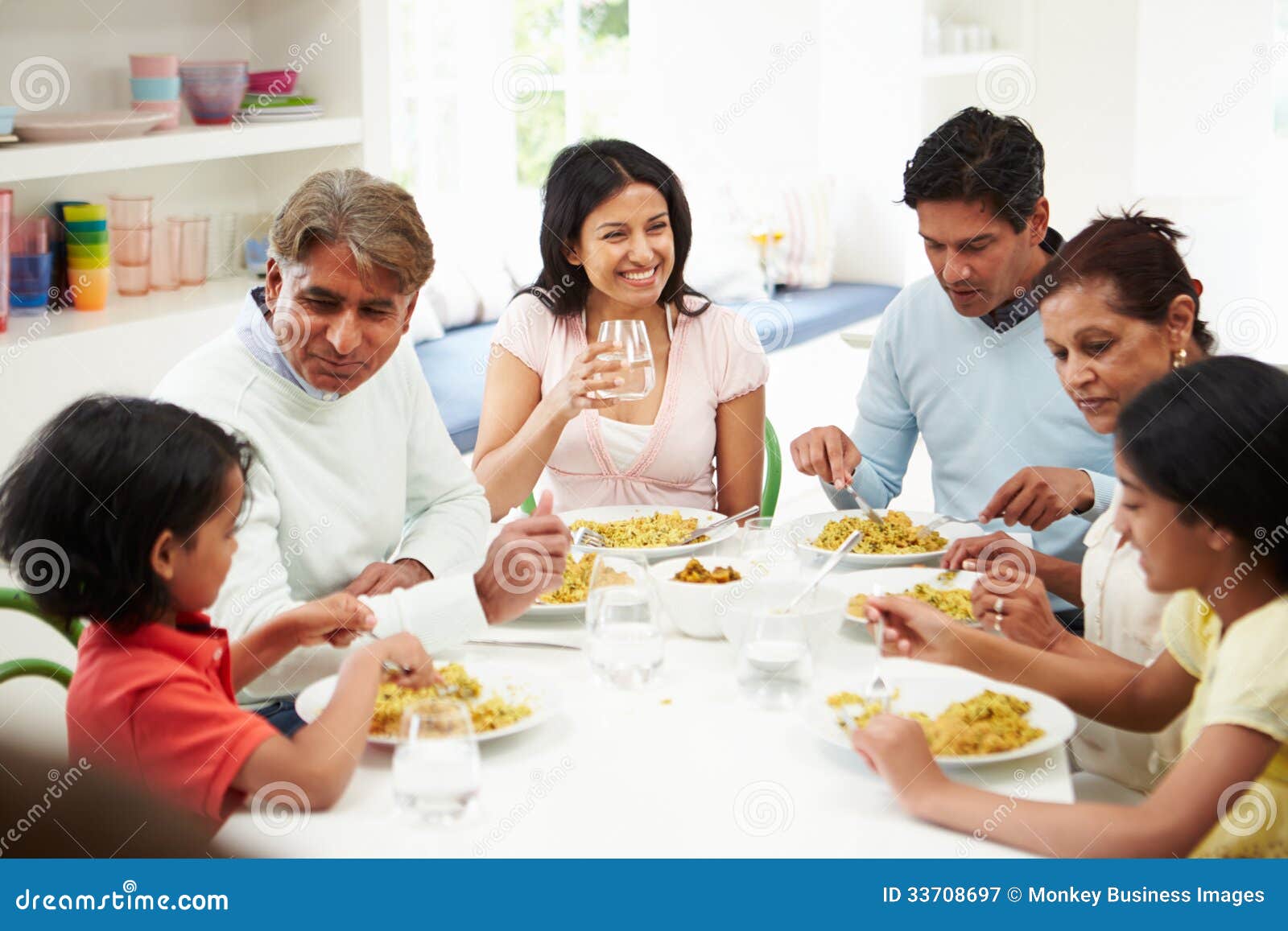 multi generation indian family eating meal at home