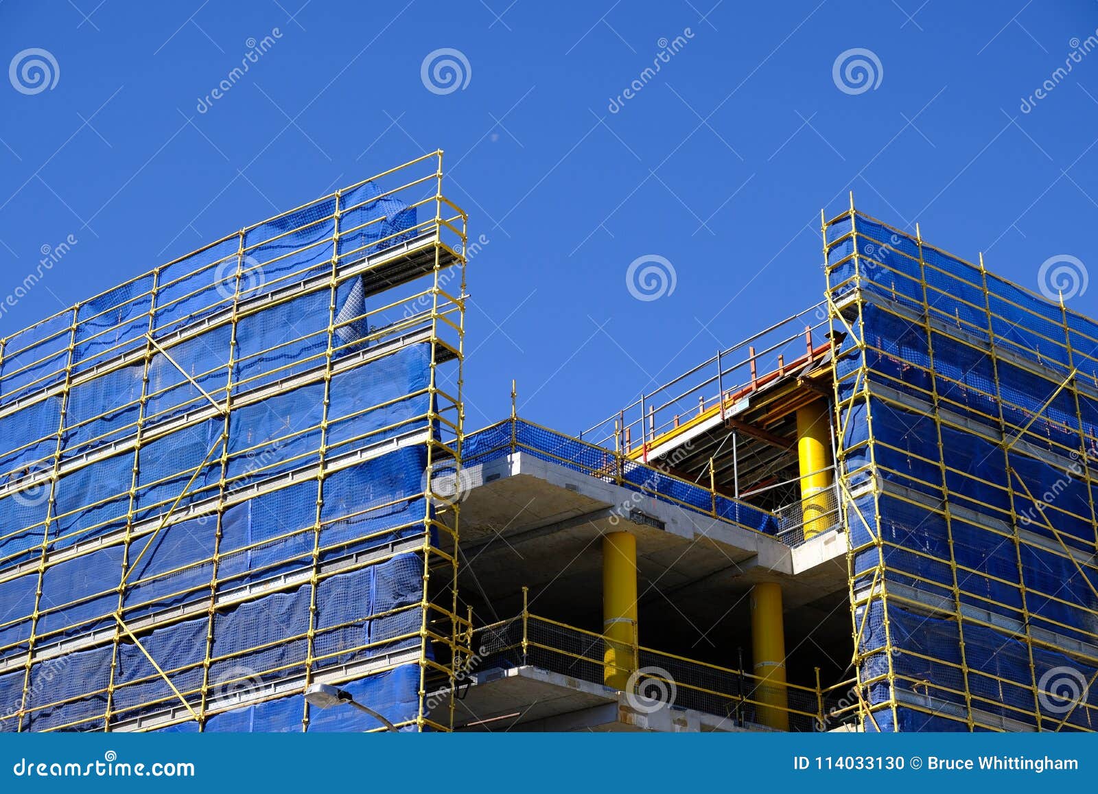 scaffolding and blue safety cladding on construction