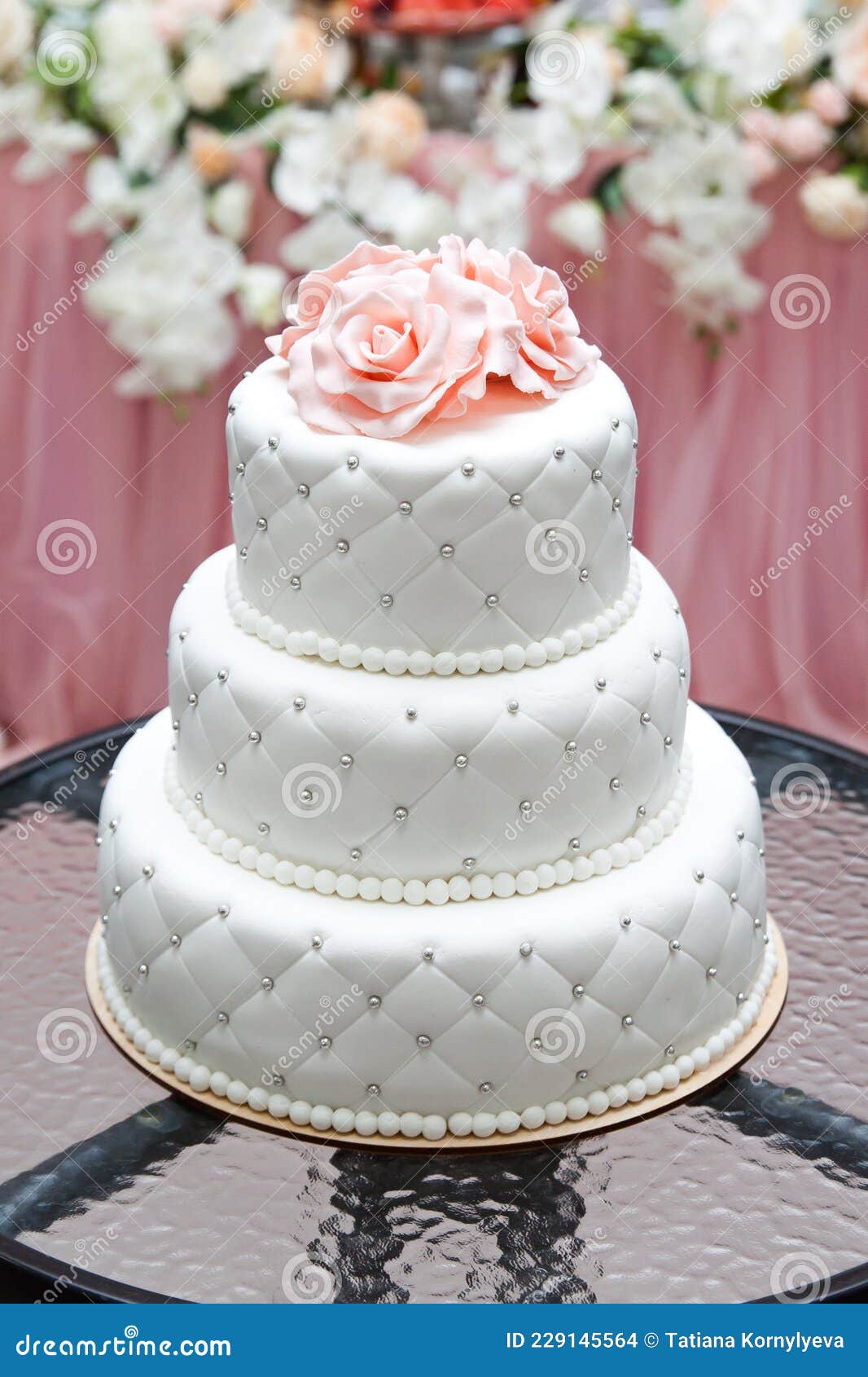 A Multi Level White Wedding Cake and Pink Flowers on Top. Big Cake ...