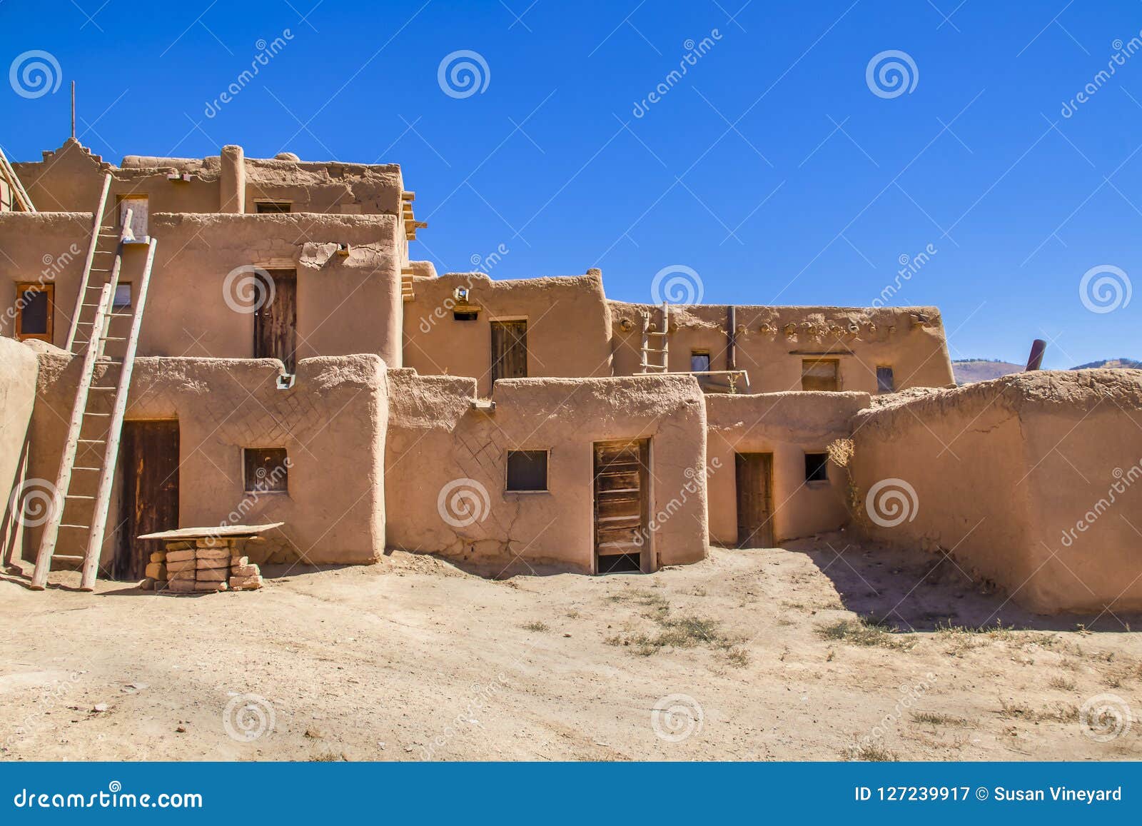 multi-story adobe buildings from taos pueblo in new mexico where indigenous people are still living after over a thousand years