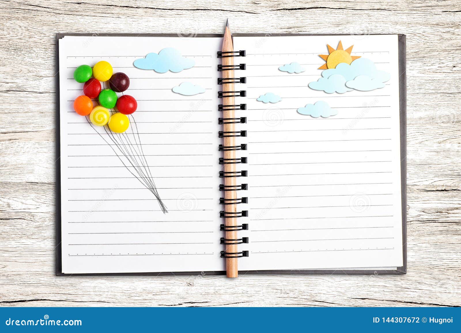 multicolor candy draw line for balloon put on open notebook